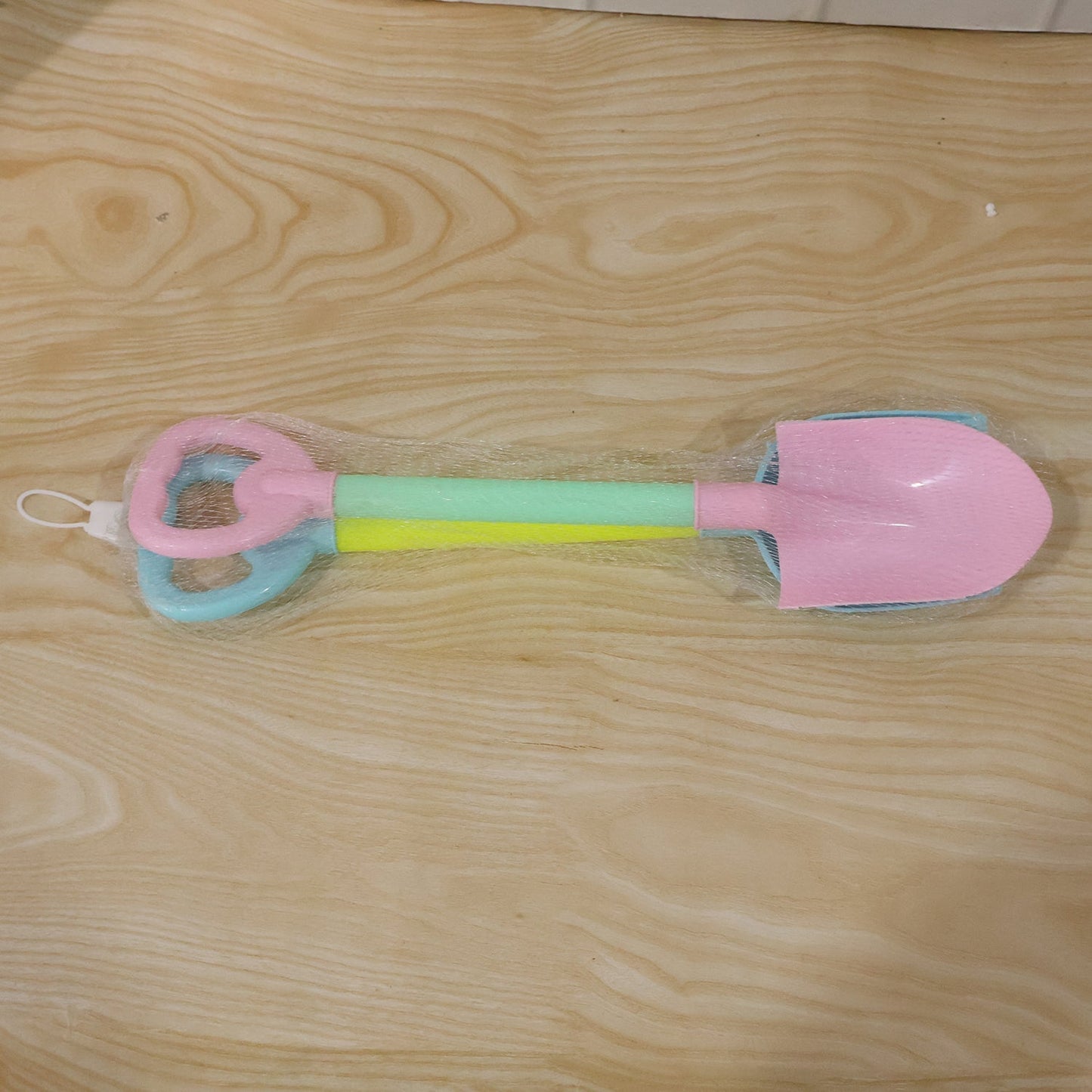 Close-up of colorful plastic sand digging tools for kids