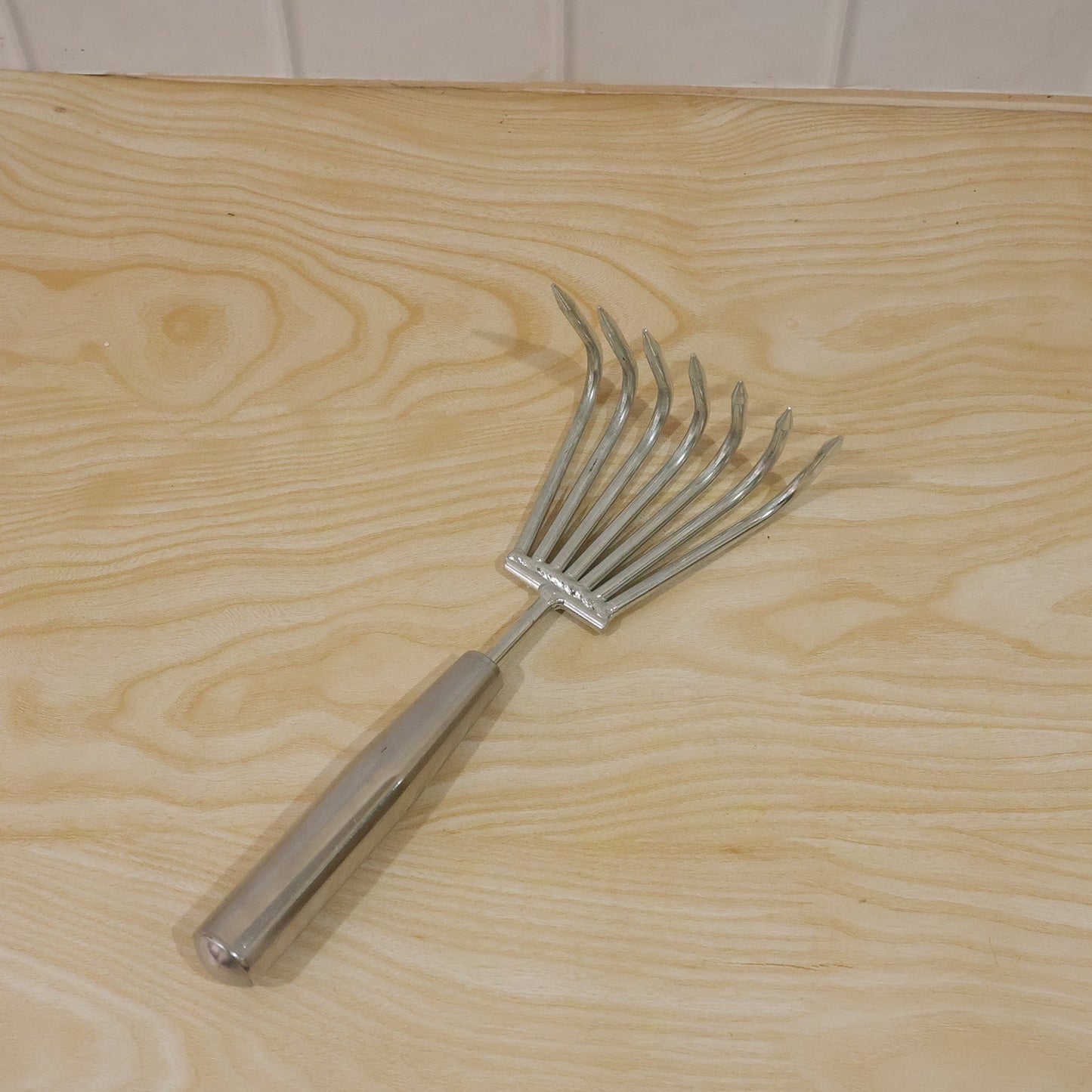 Garden rake being used for garden maintenance and raking