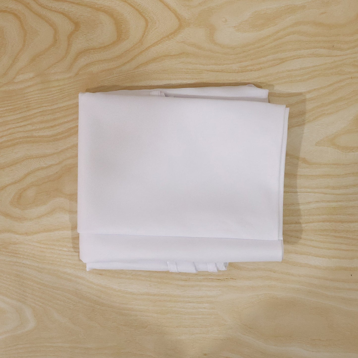 Round white table cover on a table for everyday use