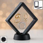 Transparent floating jewellery display box showcasing rings and earrings at an exhibition