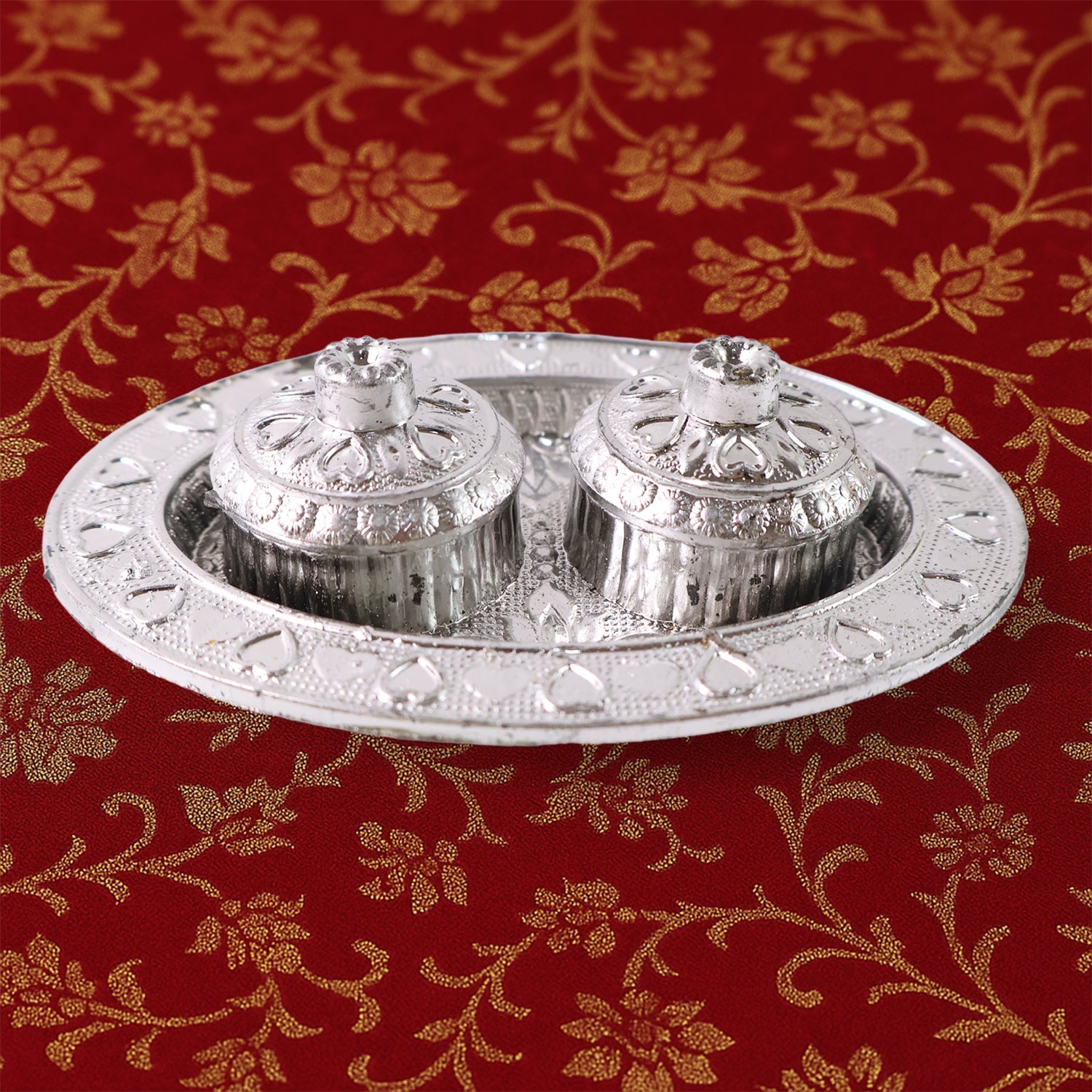 Oval kumkum holder on decorative puja thali