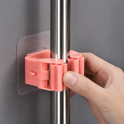 Wall-mounted mop and broom holder for organized storage