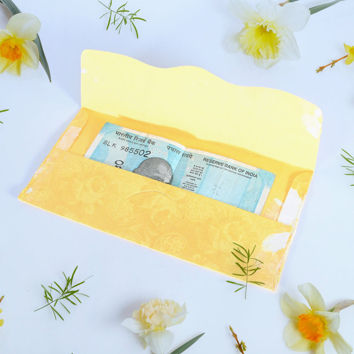 A neat stack of multicoloured premium cash gift envelopes with elegant purse handles.