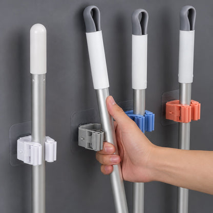 Laundry room with wall-mounted broom holder for cleaning supplies