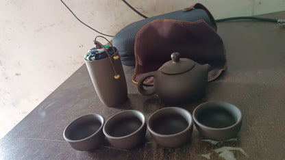 Tea set with teapot, cups & accessories on a wooden tray for travel or home