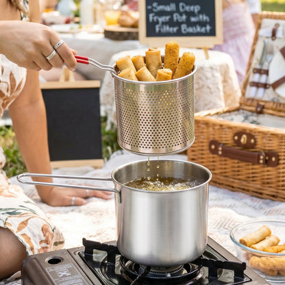 Deep frying in progress with stainless steel pot and basket