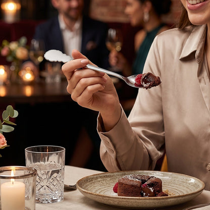 Stainless steel spoon in use during meal at dining table