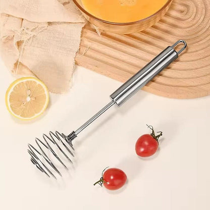 Egg beater whisk whipping ingredients in kitchen