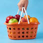 Plastic storage basket with handle featuring apple cutout design