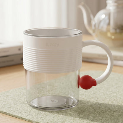 Close-up of transparent coffee mug with red accent handle