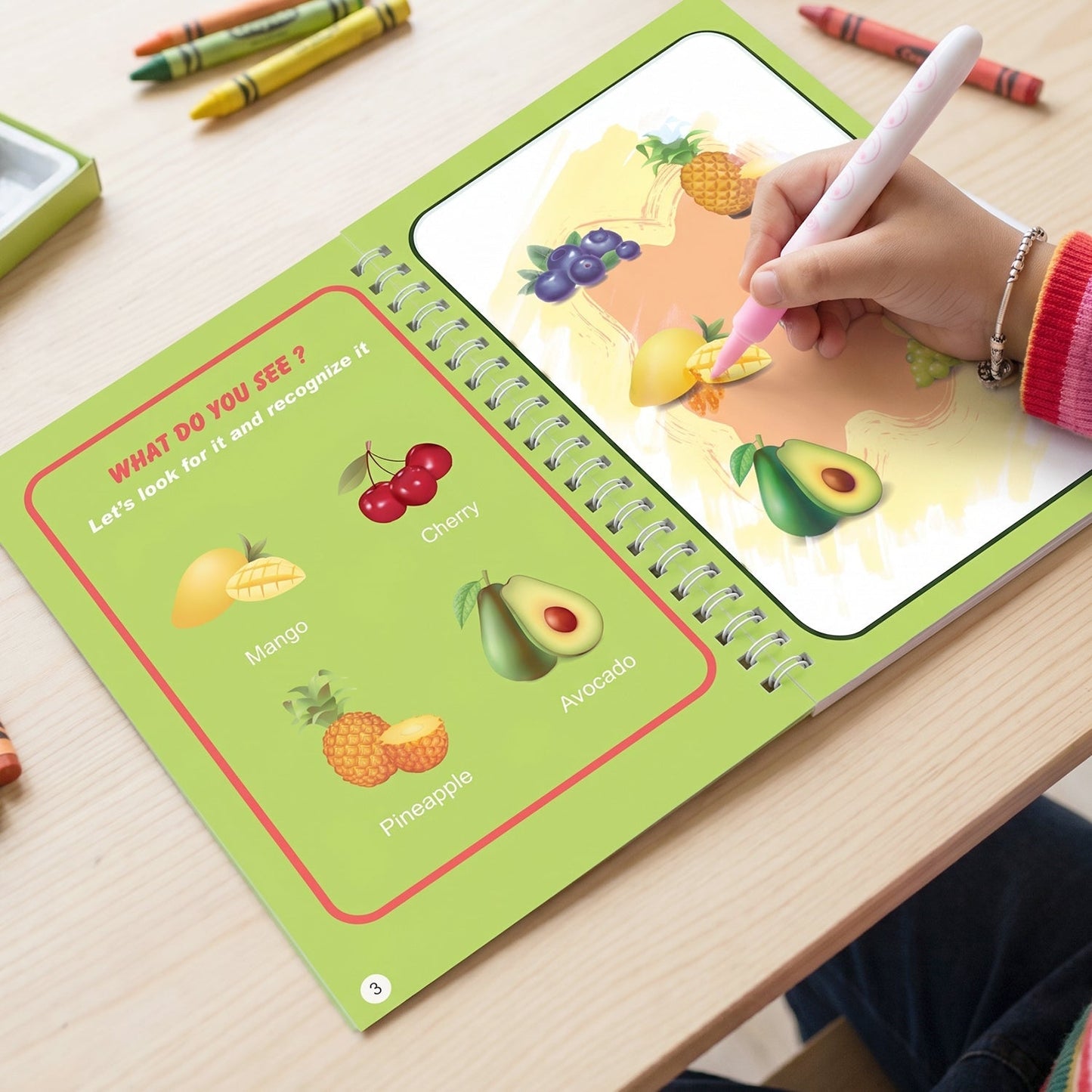 Toddler playing with magic water book, encouraging creativity
