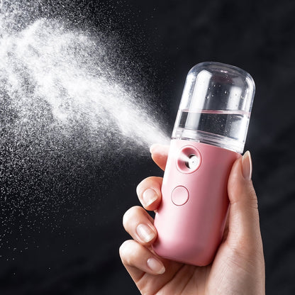 Woman using Nano Mist Sprayer on face