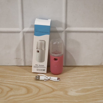 Woman using mist sprayer for daily skincare