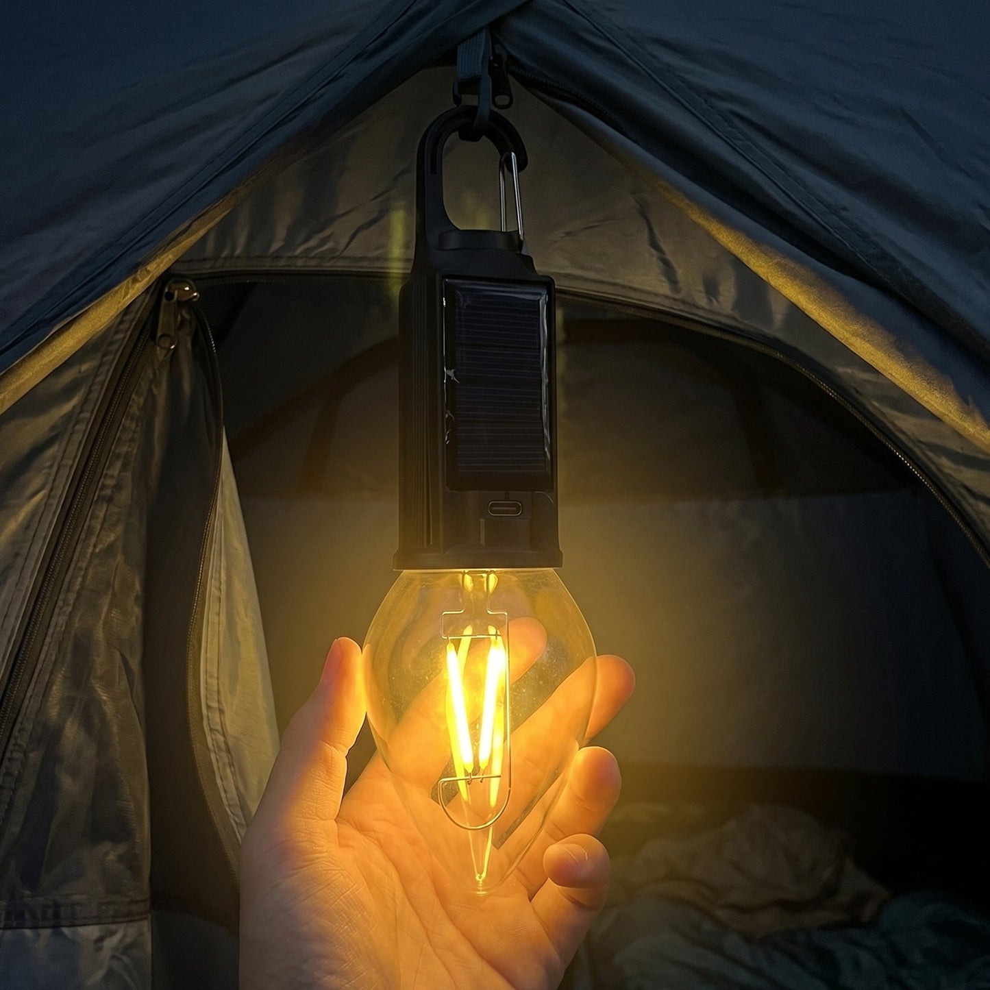 Outdoor campsite illuminated by solar camping lantern