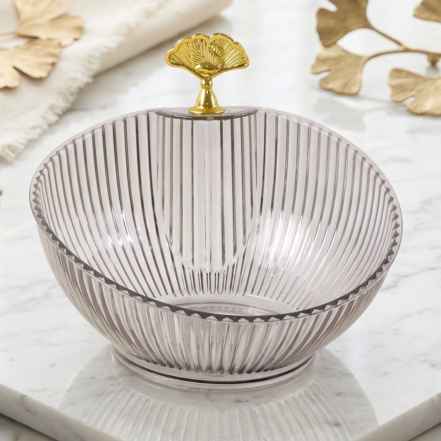Close-up of ribbed plastic design and gold leaf metal detail on decorative bowl