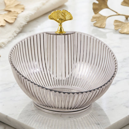 Close-up of ribbed plastic design and gold leaf metal detail on decorative bowl