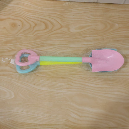Close-up of colorful plastic sand digging tools for kids