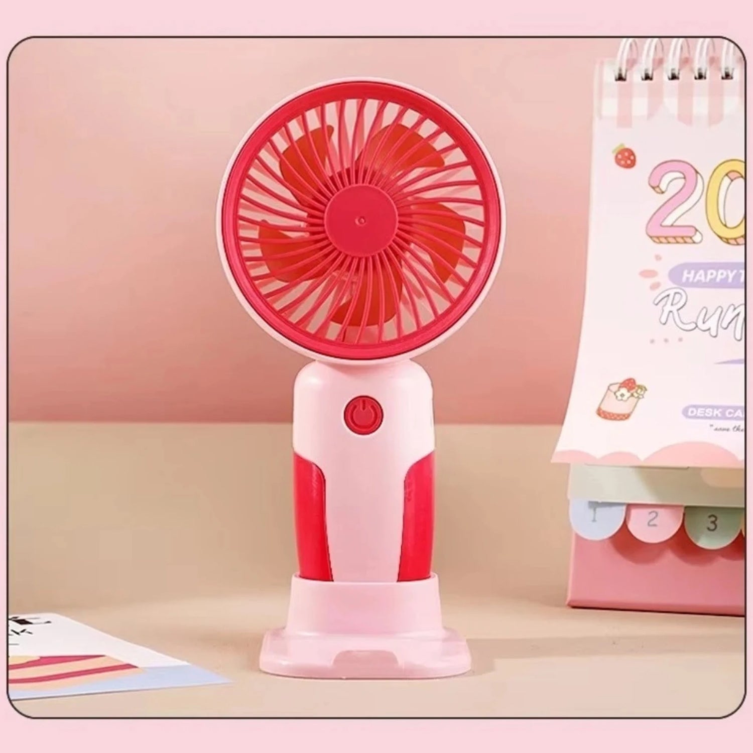Person holding portable mini fan for cooling during outdoor activities