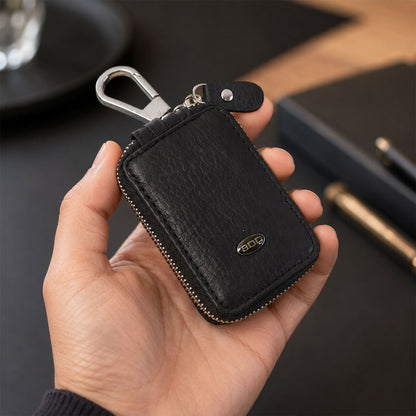 Hand holding the compact car key case, showcasing its portability.
