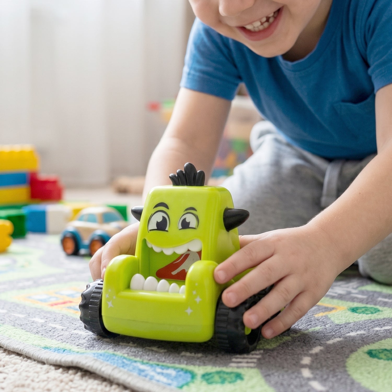 Child pushing a blue friction-powered cartoon monster car toy