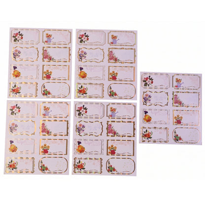 White gift tag stickers with floral gold foil accents on gift box