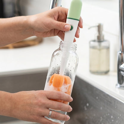 Brush being used to clean flask in kitchen