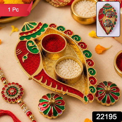 Decorative leaf shaped kankavati with red and green enamel accents