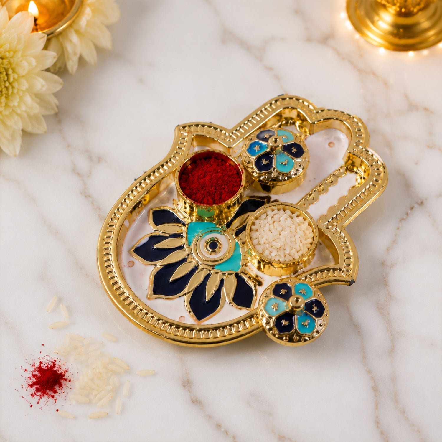 Close-up of hand-shaped kumkum holder with enamel floral design