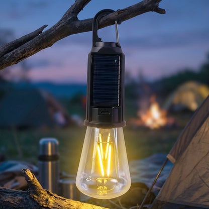 Camping lamp hanging inside a tent providing warm light