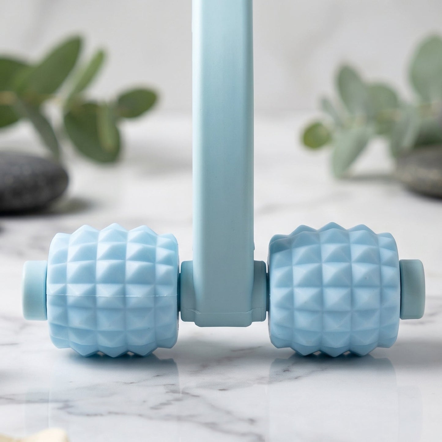 Close-up of textured balls on the handheld muscle roller.