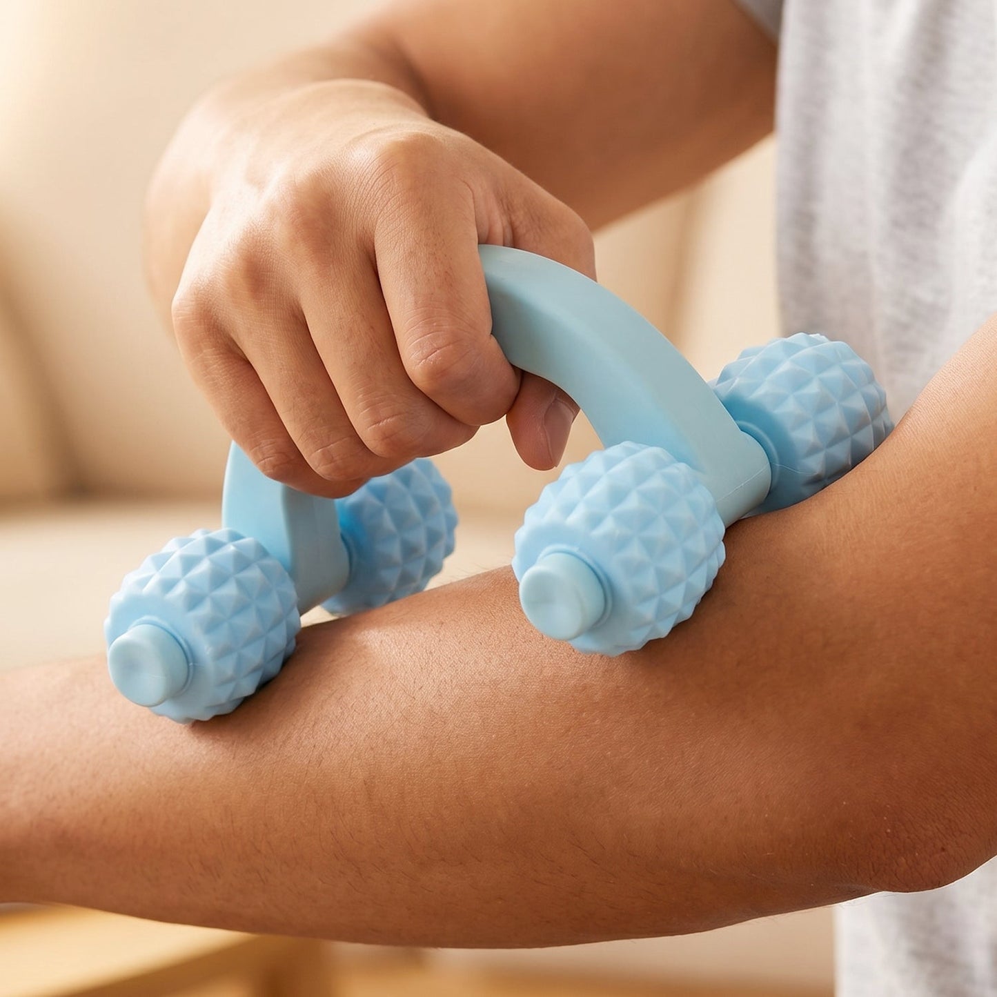 Person using the manual massager on arm muscles.