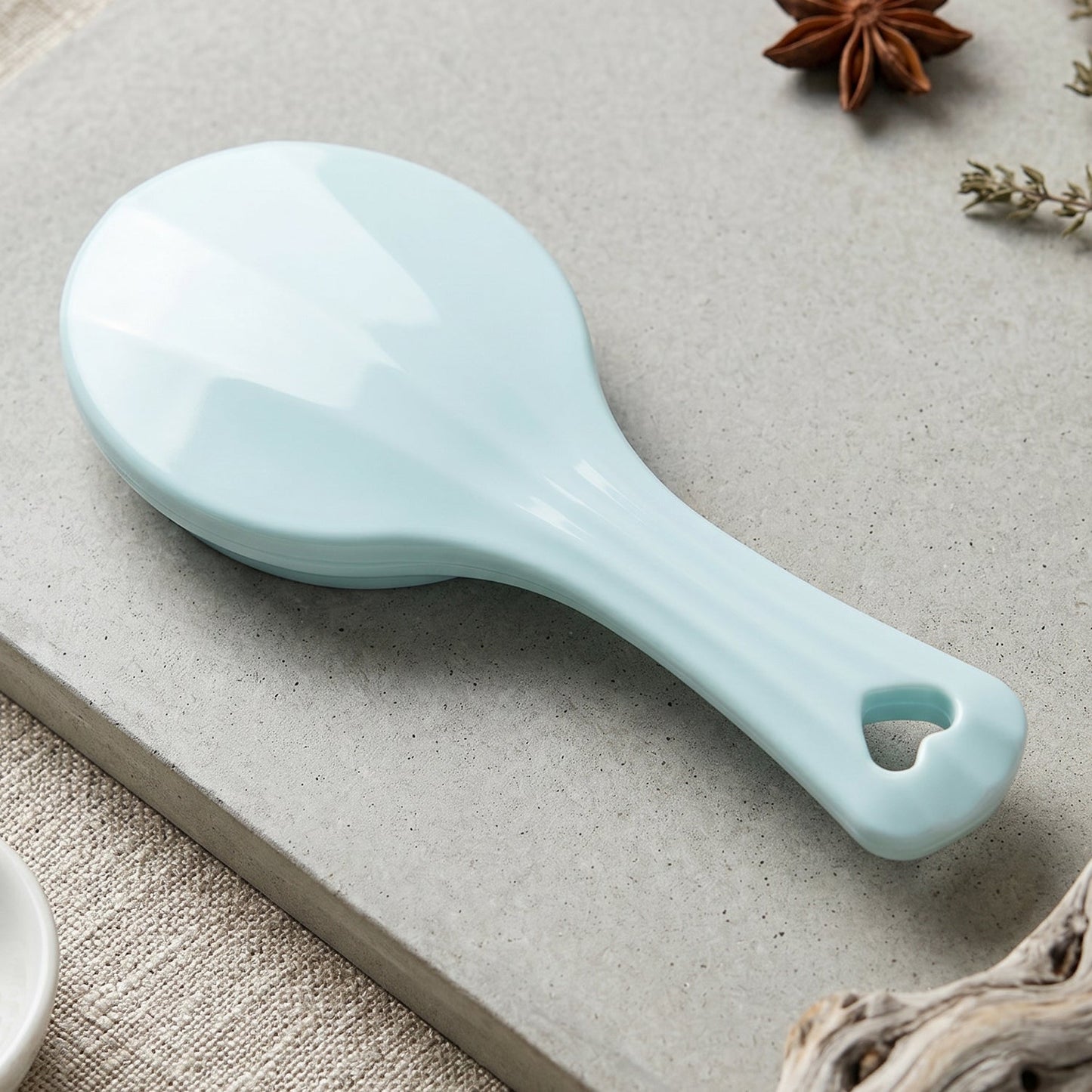 Detail view of the manual paddle massager showing steel balls.