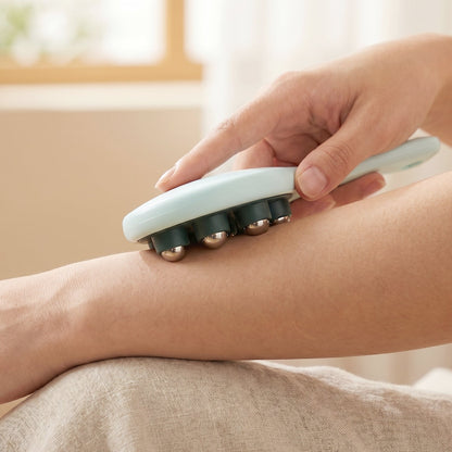 User applying steel ball massager to shoulder for muscle relief.