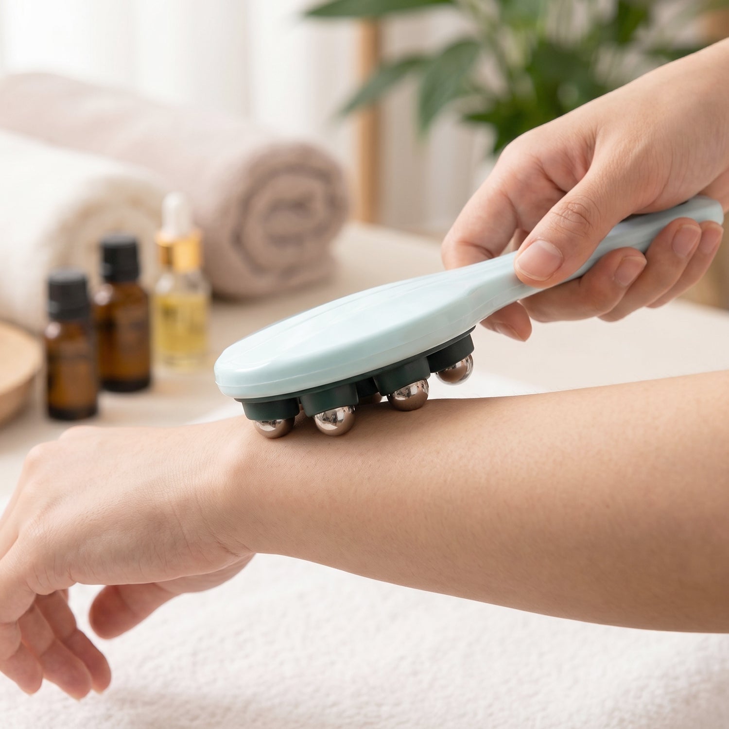 Woman using handheld massager on leg for soothing relief.