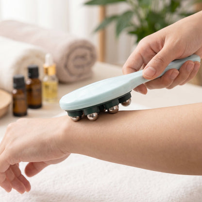 Woman using handheld massager on leg for soothing relief.