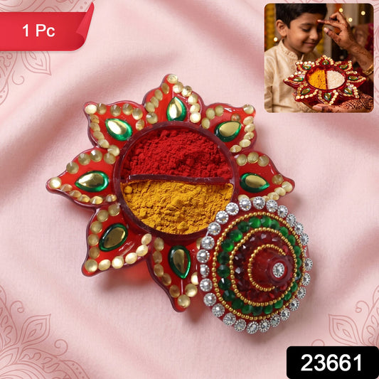 Vibrant decorative kumkum dani with intricate stone work lid.