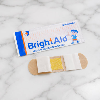 Open pack of BrightAid adhesive bandages showing multiple strips.