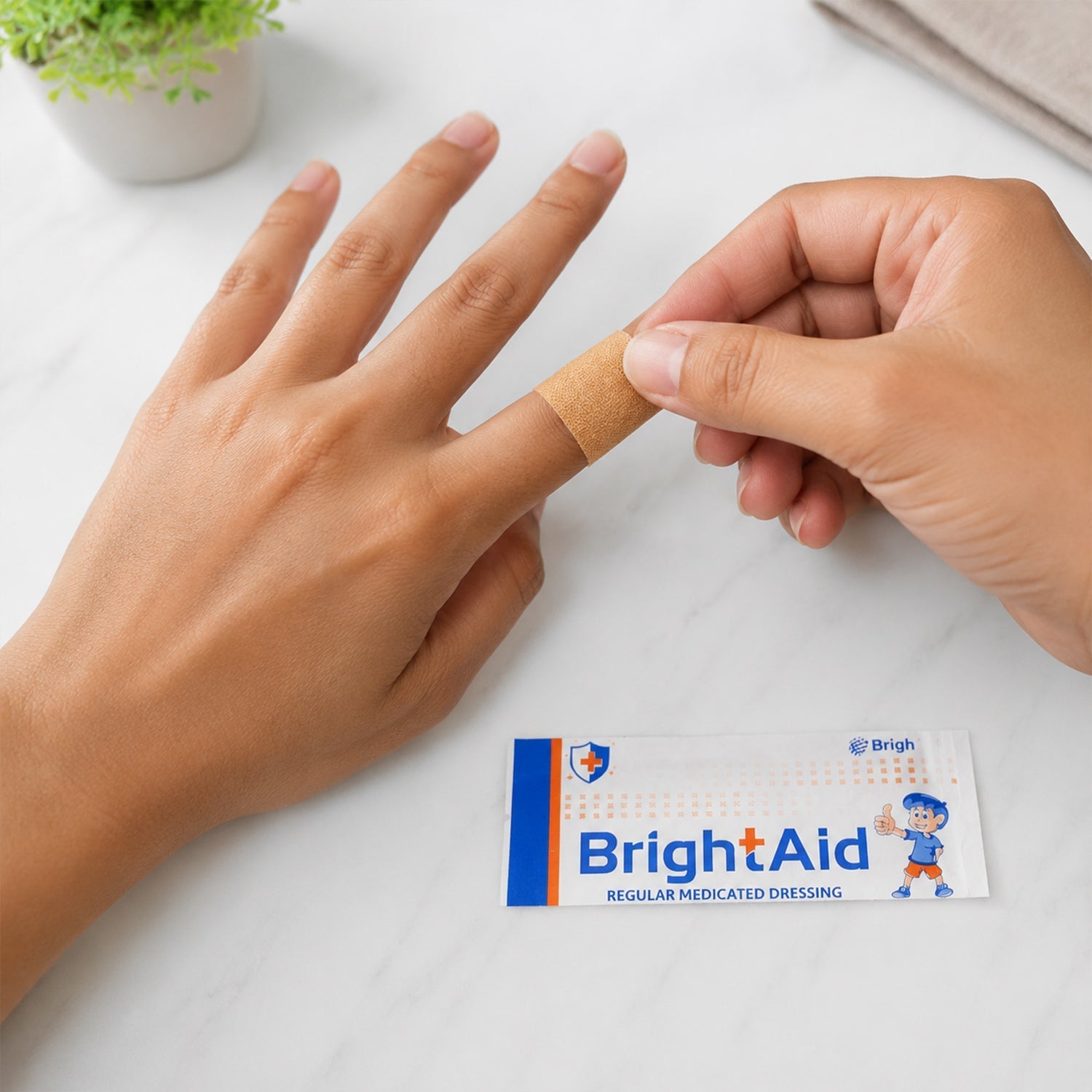 Applying a BrightAid bandage to a minor cut.