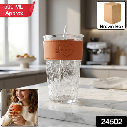 Transparent glass tumbler with lid and straw hole, ideal for cold beverages