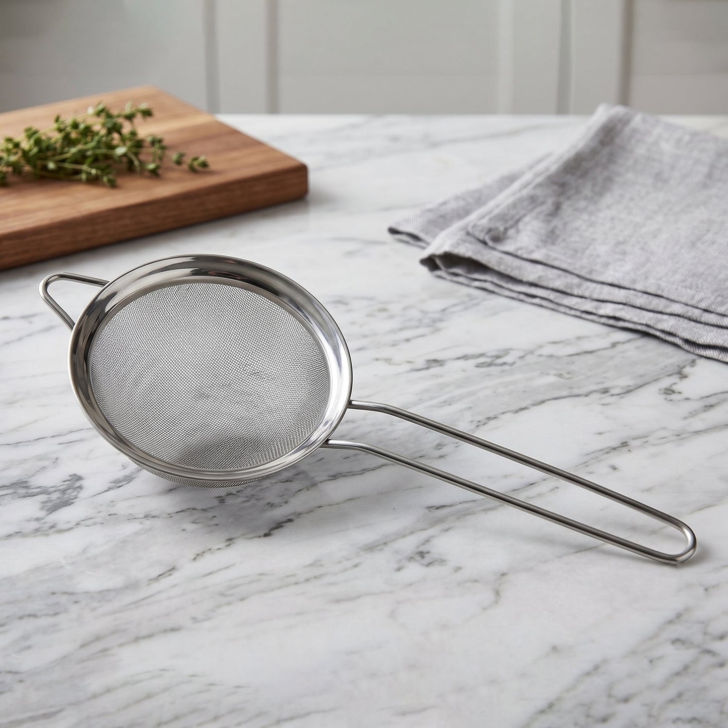 Stainless steel tea strainer with fine mesh and long handle for kitchen use