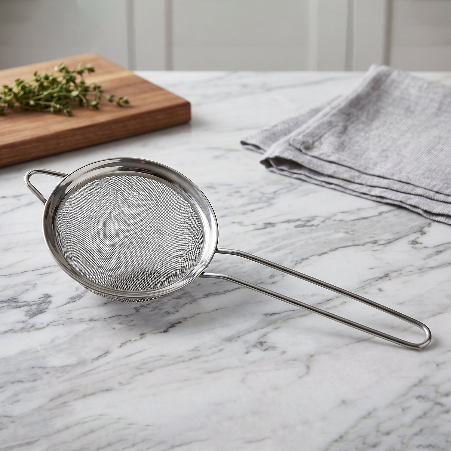 Stainless steel tea strainer with fine mesh and long handle for kitchen use