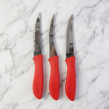 Kitchen knife slicing a tomato