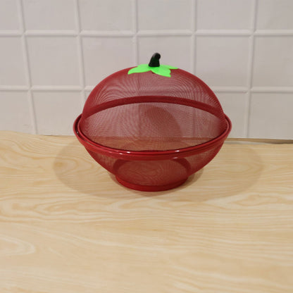 Fruit basket on kitchen counter with apple-shaped dome cover