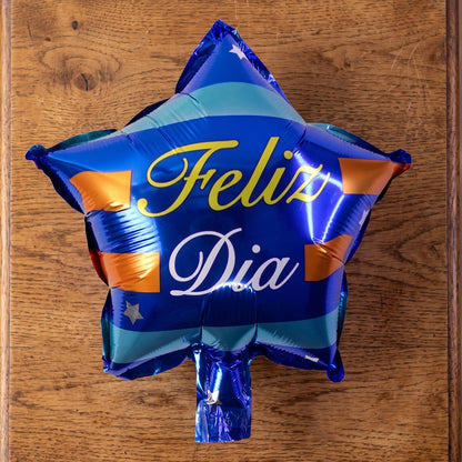 Blue star Feliz Dia foil balloon in use at a celebration