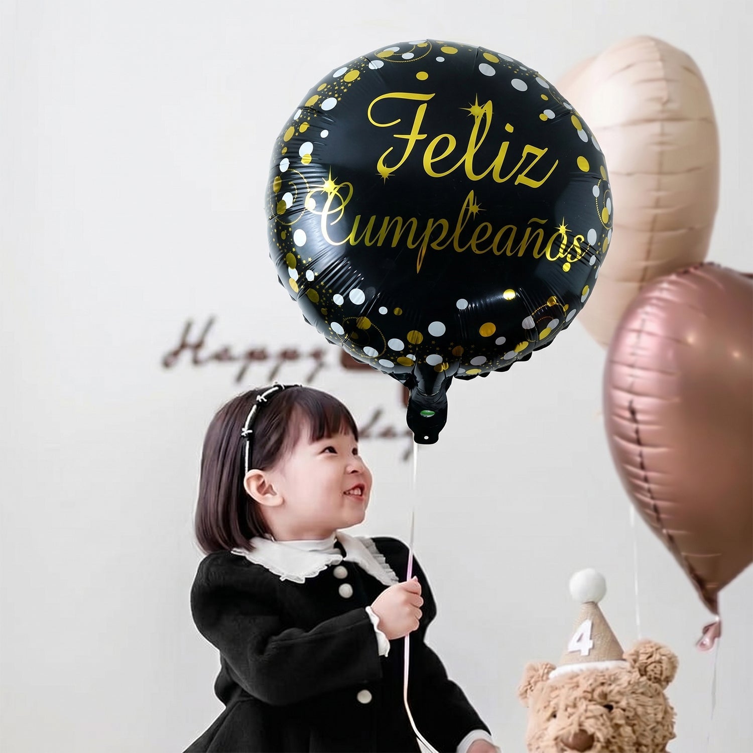 Side view of black round celebration foil balloon