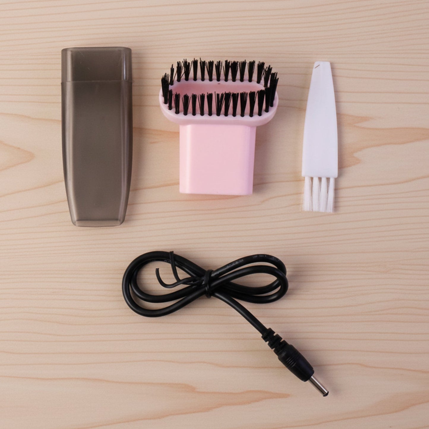 Compact vacuum cleaner with brush attachment in use