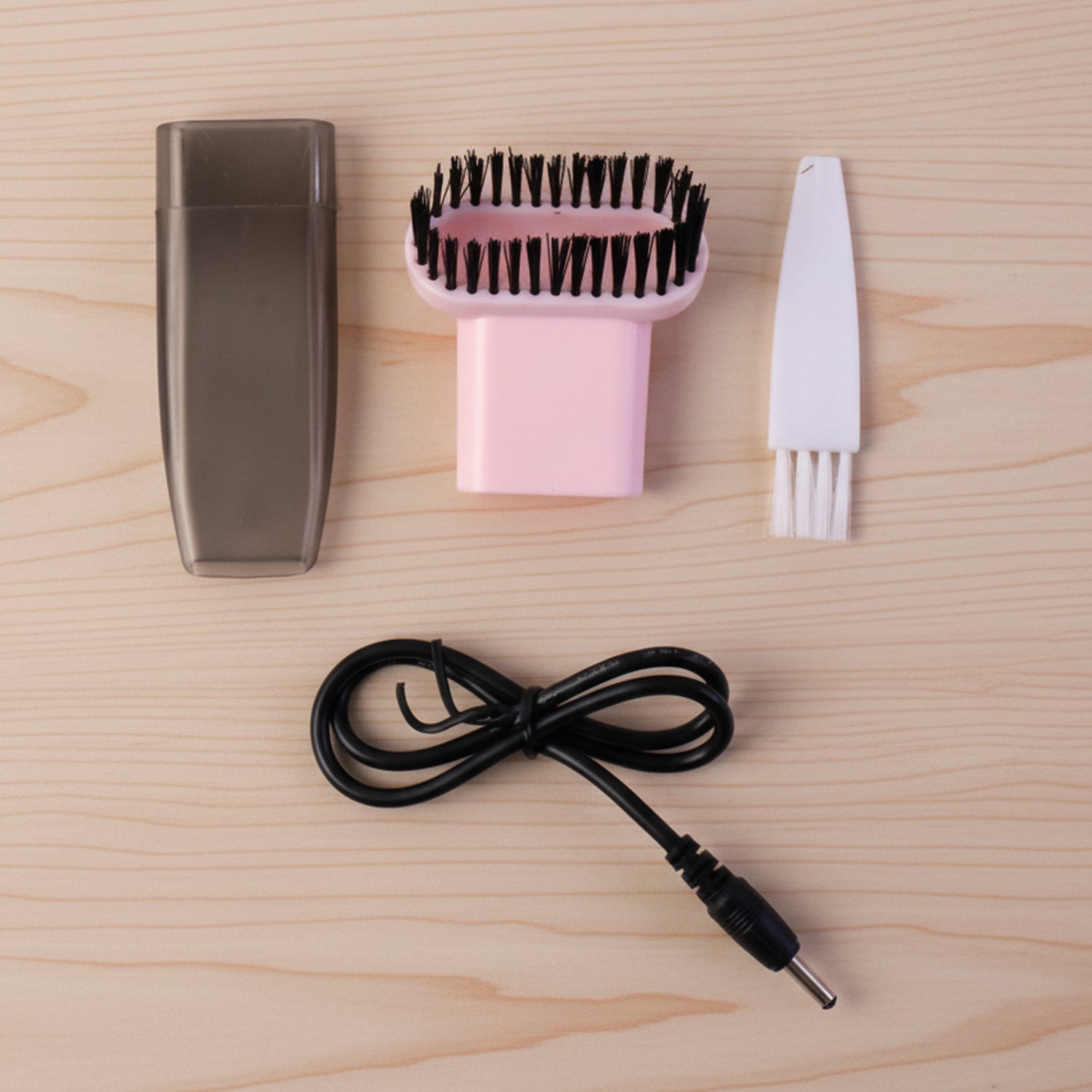 Compact vacuum cleaner with brush attachment in use
