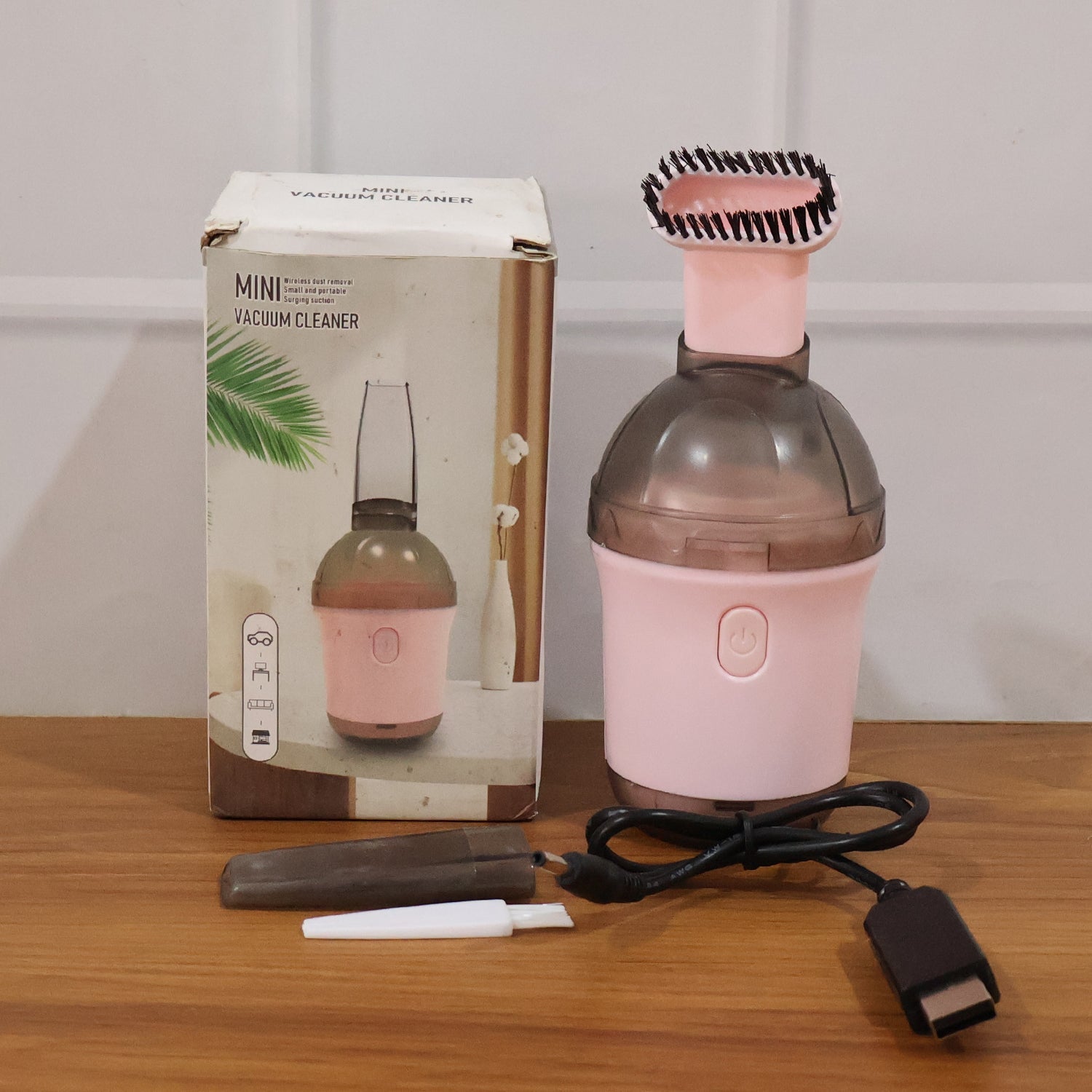 Mini vacuum cleaner in use on various surfaces