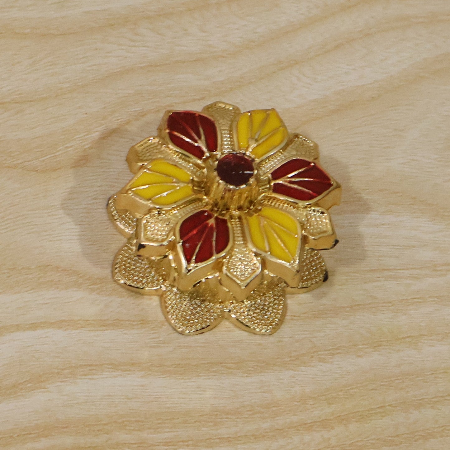 Traditional golden kumkum box for temple worship