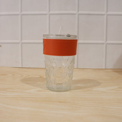 Hand holding glass tumbler with lid, perfect for daily hydration